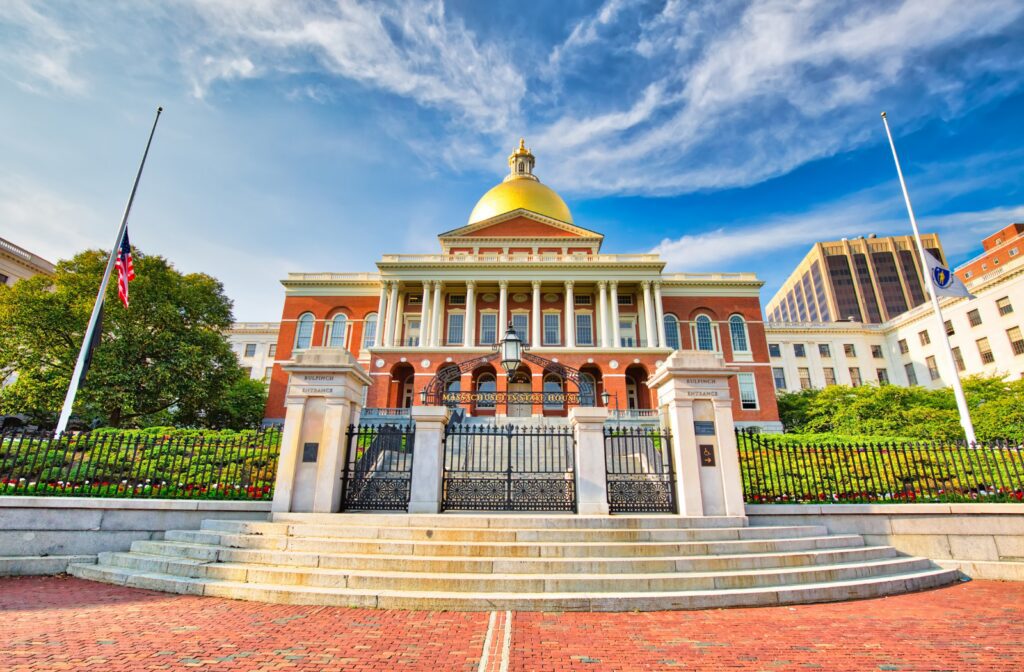 Massachusetts Question 8 workforce plan for cannabis employers shown with a manager meeting a dispensary team to discuss planning